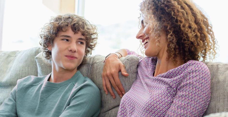 White mom and son smiling on couch_Letizia Le Fur-GettyImages-667595665_5491x3661-edited